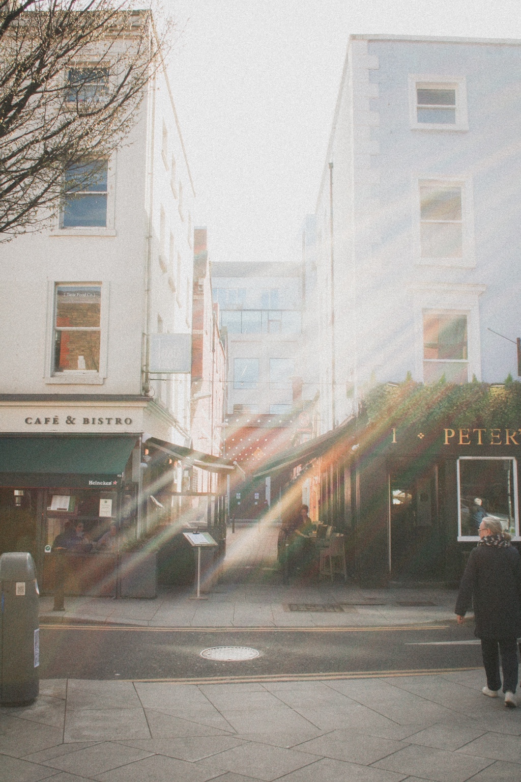 Sunlight streaming through a city café street