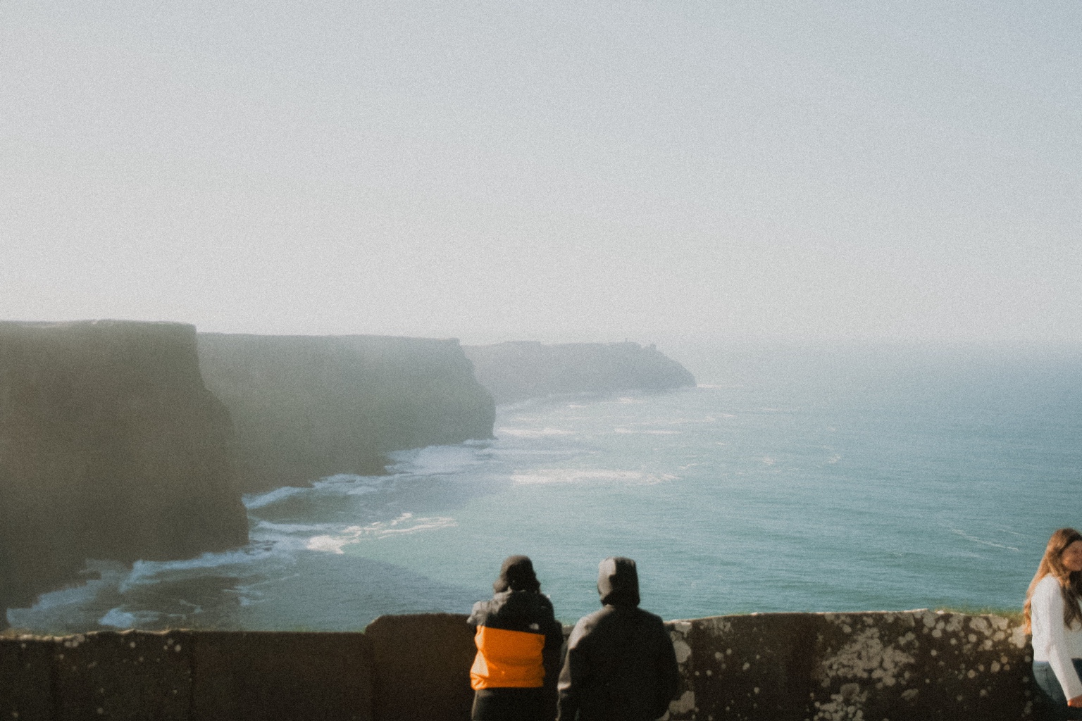 People looking over the cliffs and ocean